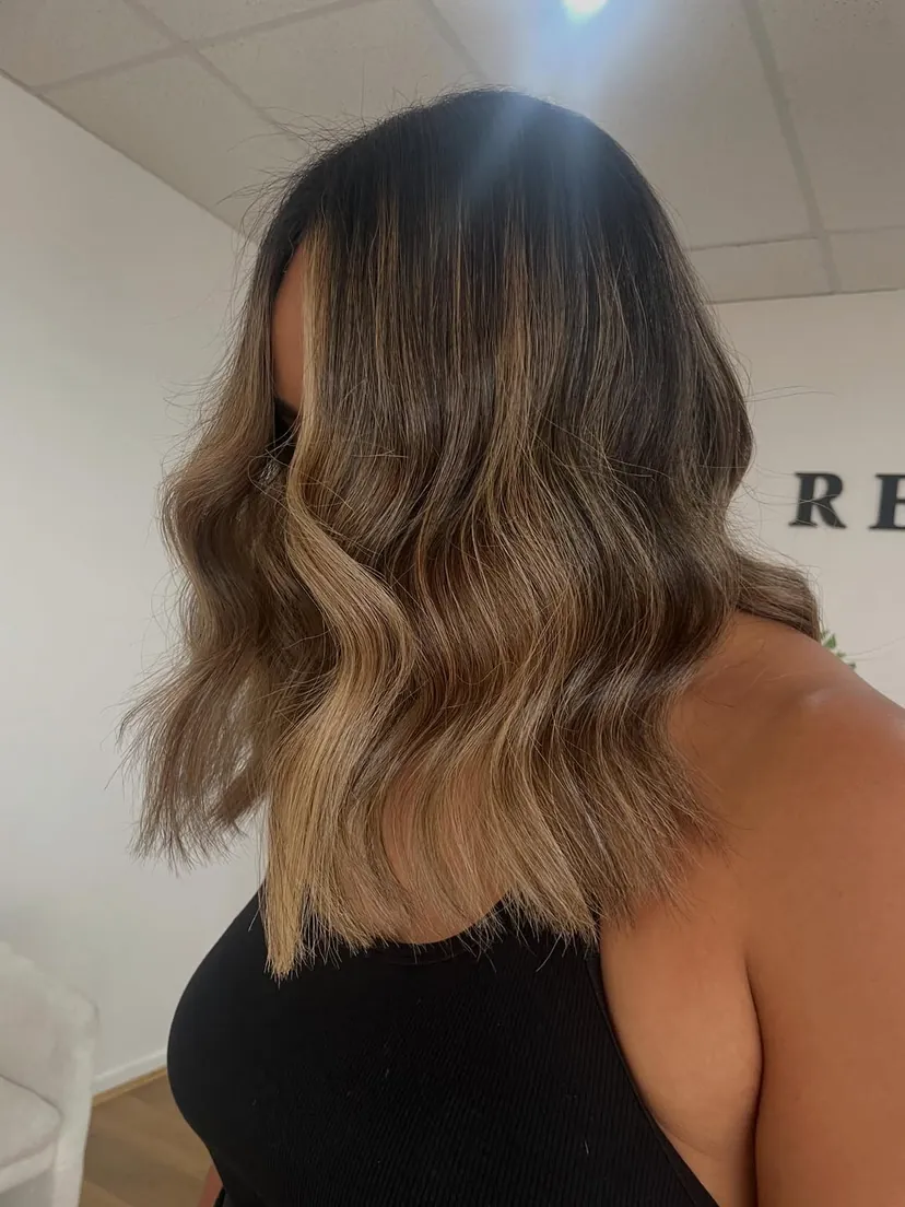 After: Biscuit blonde on naturally dark hair. Seamless blends, soft dimension and months of wear with no harsh regrowth.