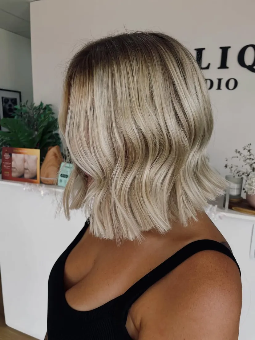 After: Uneven banding from a previous blonde fixed, brightened right up and finished with a blunt bob. Ten tape sandwiches fill the face frame.