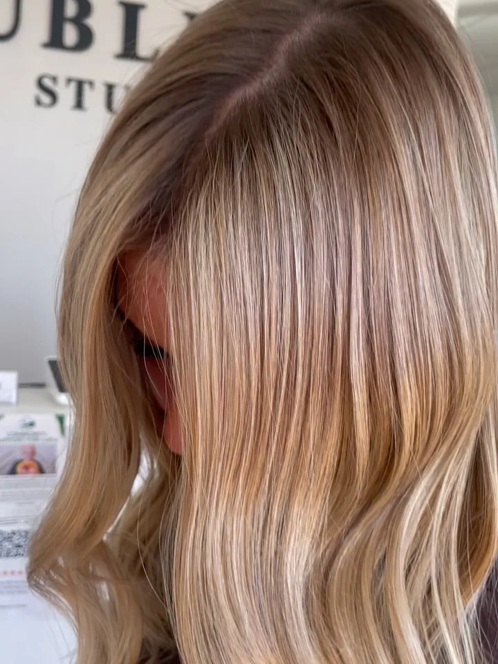 After: Warm orange tones from Sun Bum on virgin hair, turned into a brighter, dimensional blonde that grows out beautifully.